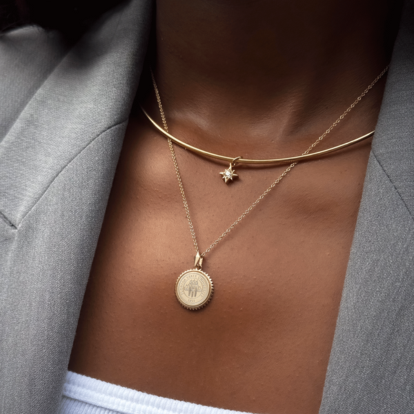 North Star Charm shown on figure in gold on Neck Collar with FSU Sunburst on Cable Chain