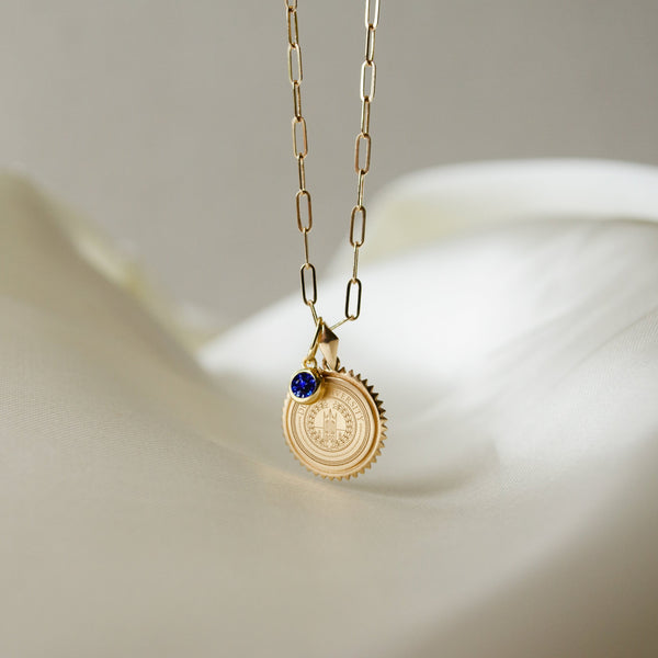 Duke University Seal Sunburst shown as a Sunburst Bundle on Link Chain with Sapphire Gemstone Charm in gold