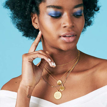 Gold Delta Delta Delta Sunburst Letters Necklace on Model